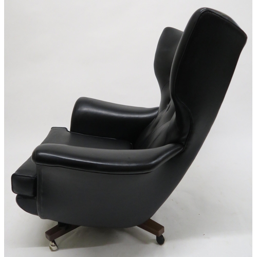 106 - A MID 20TH CENTURY G PLAN 6250 SWIVEL ARMCHAIRupholstered in black Rexine on teak base, 100cm high x... 