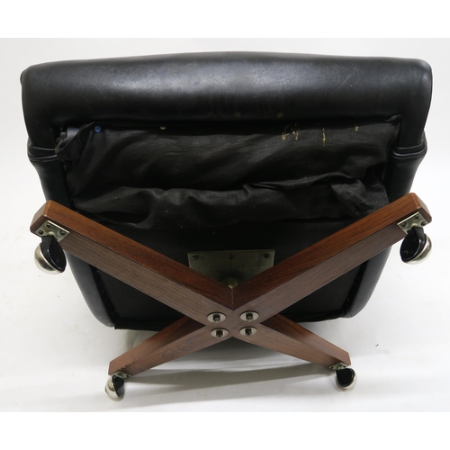 106 - A MID 20TH CENTURY G PLAN 6250 SWIVEL ARMCHAIRupholstered in black Rexine on teak base, 100cm high x... 