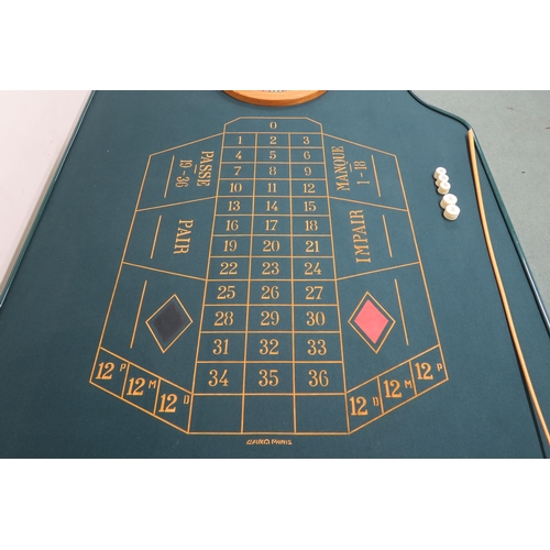 112 - A 20TH CENTURY FRENCH CASINO ROULETTE TABLE PRODUCED BY CARO OF PARIS, baize shaped top, mahogany an... 