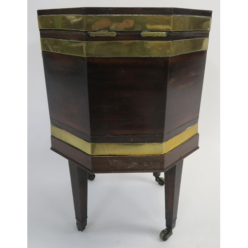 12 - AN EARLY 19TH CENTURY MAHOGANY OCTAGONAL CELLARETTE ON STAND with brass strap banding and handles on... 