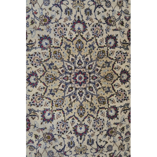 120 - A CREAM GROUND PERSIAN HAND KNOTTED FINE KASHAN RUG with central medallion and matching spandrels 34... 