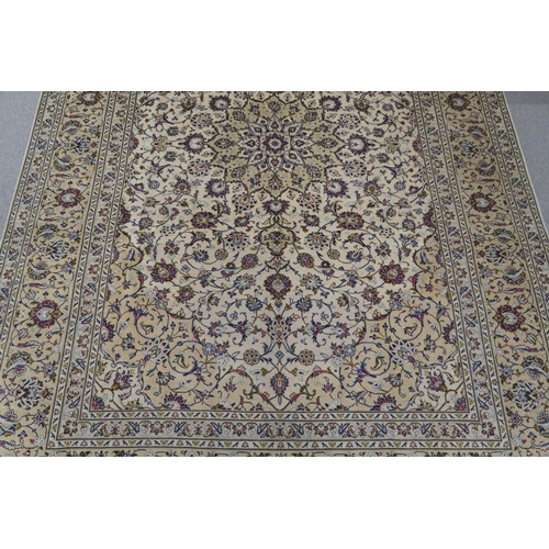 120 - A CREAM GROUND PERSIAN HAND KNOTTED FINE KASHAN RUG with central medallion and matching spandrels 34... 