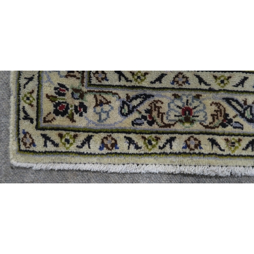 120 - A CREAM GROUND PERSIAN HAND KNOTTED FINE KASHAN RUG with central medallion and matching spandrels 34... 