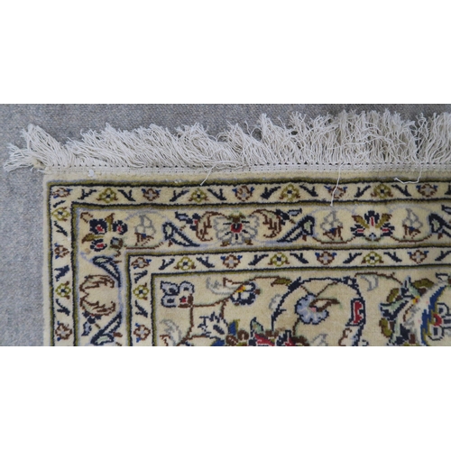 120 - A CREAM GROUND PERSIAN HAND KNOTTED FINE KASHAN RUG with central medallion and matching spandrels 34... 