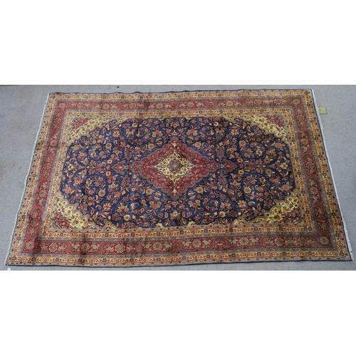 122 - A DARK BLUE GROUND TABRIZ RUG with red and cream central medallion,matching spandrels and red border... 