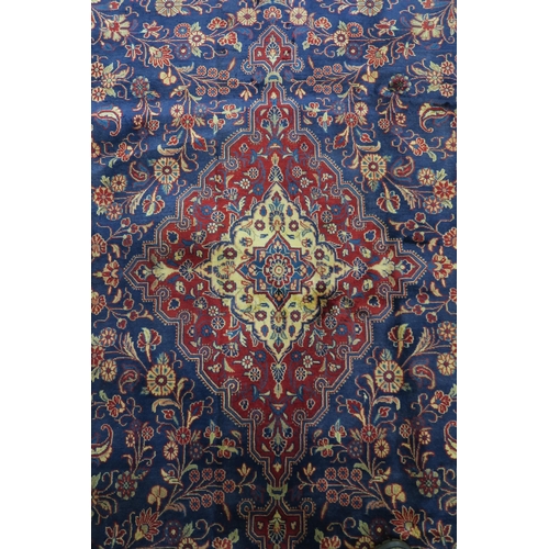 122 - A DARK BLUE GROUND TABRIZ RUG with red and cream central medallion,matching spandrels and red border... 