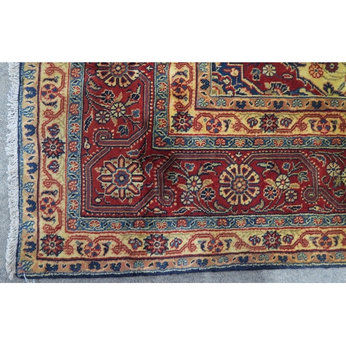 122 - A DARK BLUE GROUND TABRIZ RUG with red and cream central medallion,matching spandrels and red border... 