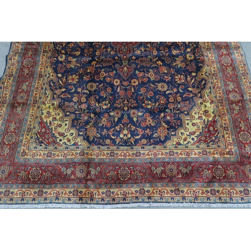 122 - A DARK BLUE GROUND TABRIZ RUG with red and cream central medallion,matching spandrels and red border... 