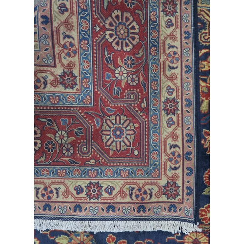 122 - A DARK BLUE GROUND TABRIZ RUG with red and cream central medallion,matching spandrels and red border... 