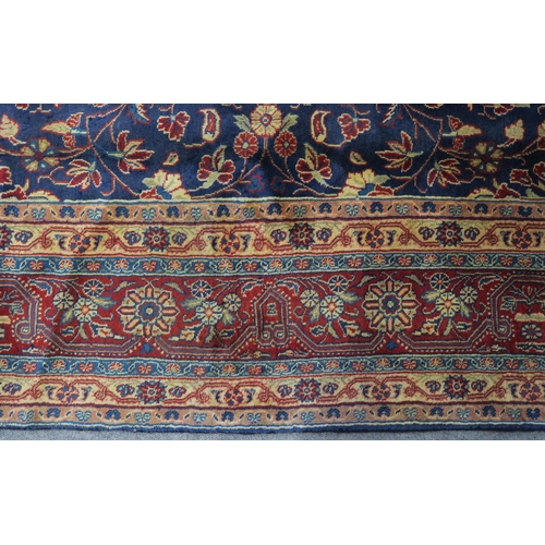 122 - A DARK BLUE GROUND TABRIZ RUG with red and cream central medallion,matching spandrels and red border... 