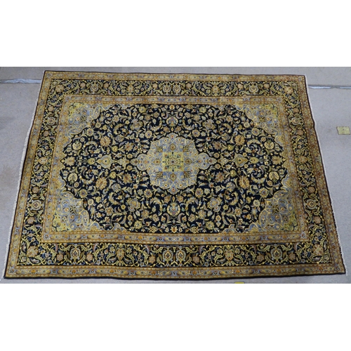 123 - A DARK BLUE GROUND KASHAN RUG with light blue central medallion ,matching spandrels and dark blue bo... 