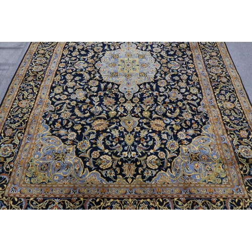 123 - A DARK BLUE GROUND KASHAN RUG with light blue central medallion ,matching spandrels and dark blue bo... 