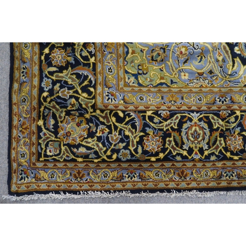 123 - A DARK BLUE GROUND KASHAN RUG with light blue central medallion ,matching spandrels and dark blue bo... 