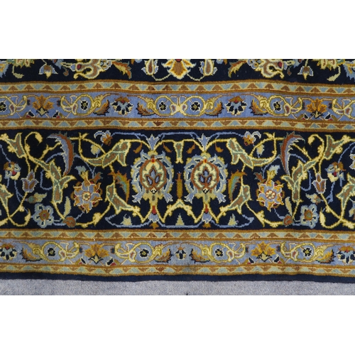 123 - A DARK BLUE GROUND KASHAN RUG with light blue central medallion ,matching spandrels and dark blue bo... 