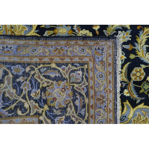 123 - A DARK BLUE GROUND KASHAN RUG with light blue central medallion ,matching spandrels and dark blue bo... 