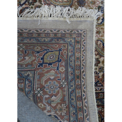 124 - A CREAM GROUND TABRIZ RUG with a light terracotta medallion, matching borders and dark blue spandrel... 