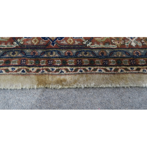 124 - A CREAM GROUND TABRIZ RUG with a light terracotta medallion, matching borders and dark blue spandrel... 