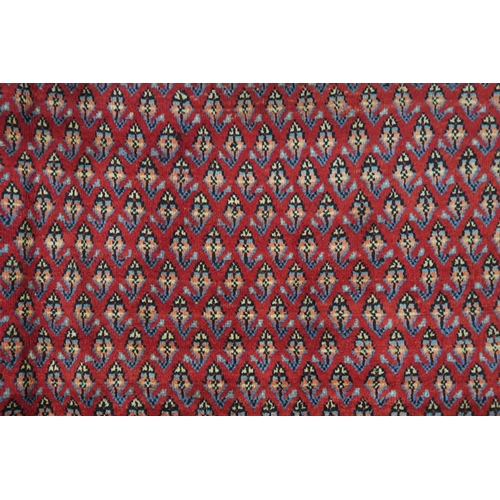 125 - A RED GROUND ARAAK RUG with multicoloured geometric borders 370cm long x 283cm wide... 