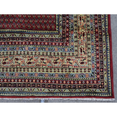 125 - A RED GROUND ARAAK RUG with multicoloured geometric borders 370cm long x 283cm wide... 