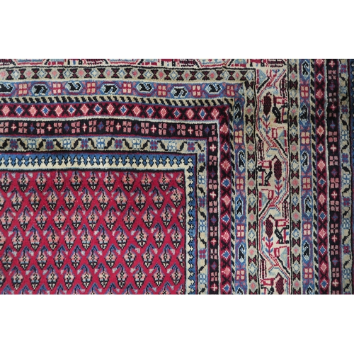 125 - A RED GROUND ARAAK RUG with multicoloured geometric borders 370cm long x 283cm wide... 