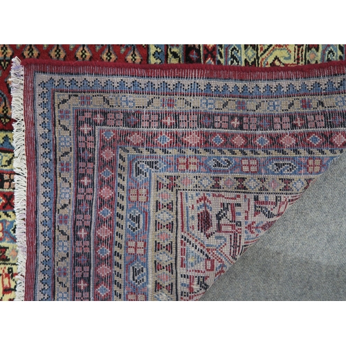 125 - A RED GROUND ARAAK RUG with multicoloured geometric borders 370cm long x 283cm wide... 