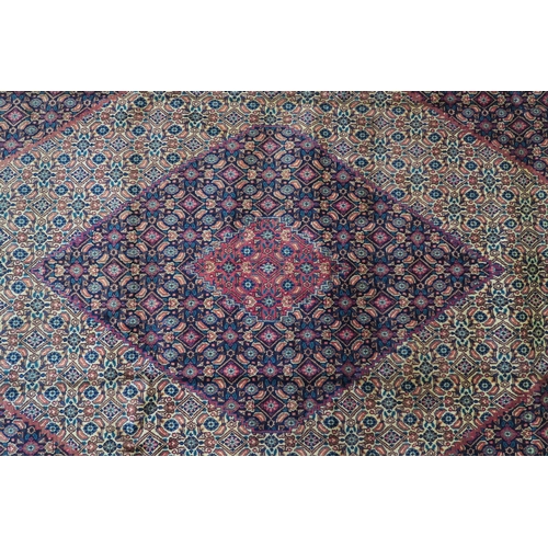 126 - A MULTICOLOURED GROUND TABRIZ RUG with red diamond central medallion and matching borders 289cm long... 