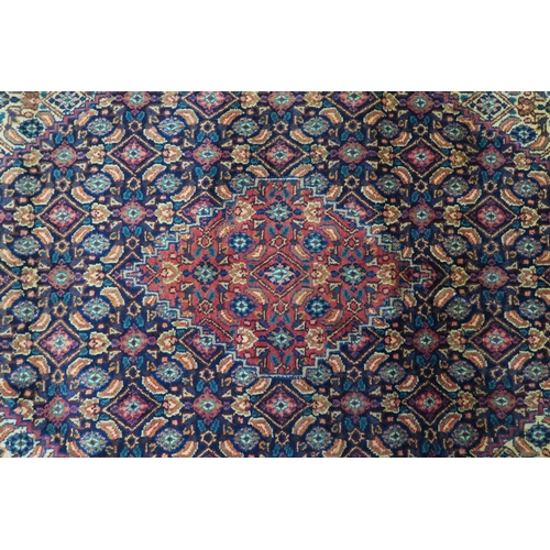 126 - A MULTICOLOURED GROUND TABRIZ RUG with red diamond central medallion and matching borders 289cm long... 