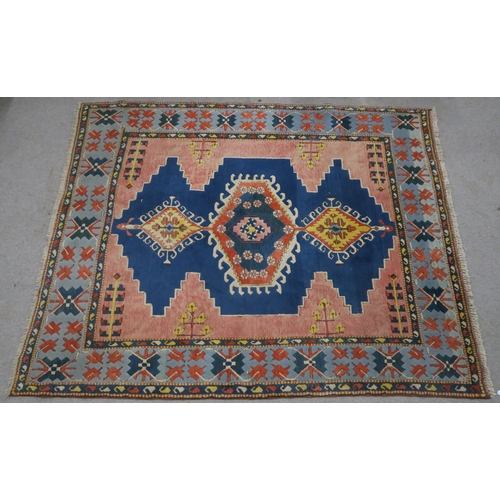 127 - A PINK & BLUE GROUND TURKISH KAYAM RUG with floral geometric central medallion and multicoloured... 