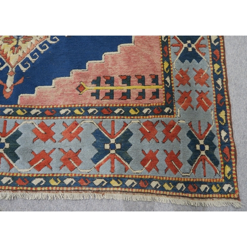 127 - A PINK & BLUE GROUND TURKISH KAYAM RUG with floral geometric central medallion and multicoloured... 