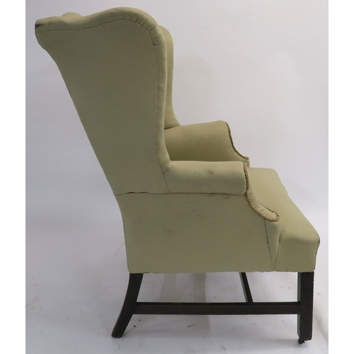 13 - A GEORGIAN WINGBACK ARMCHAIR on mahogany square tapering legs, joined by a stretcher, 110cm high... 