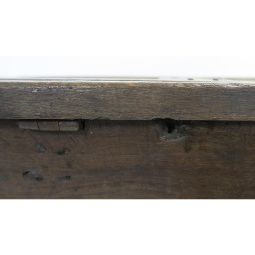 15 - AN 18TH CENTURY OAK COFFER the hinged lid set with three panels above a carved foliate frieze and th... 