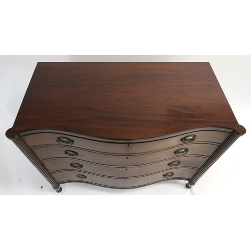 16 - A 19TH CENTURY MAHOGANY SERPENTINE CHEST with four graduating drawers, flanked by fluted columns and... 