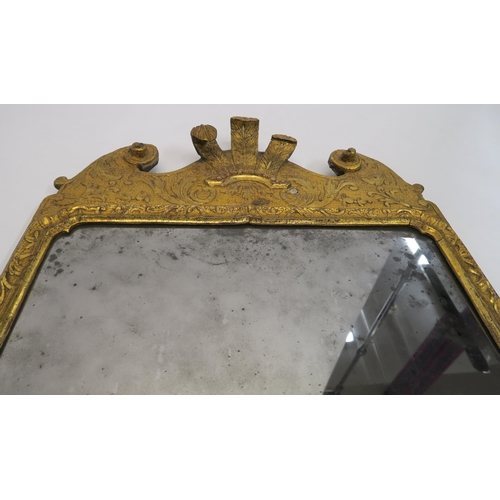 18 - A GEORGIAN GILT WOOD AND GESSO WALL MIRROR carved with Prince of Wales feathers, flanked by foliate ... 