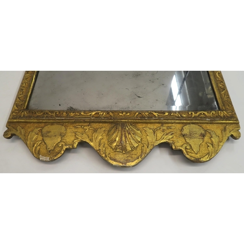 18 - A GEORGIAN GILT WOOD AND GESSO WALL MIRROR carved with Prince of Wales feathers, flanked by foliate ... 