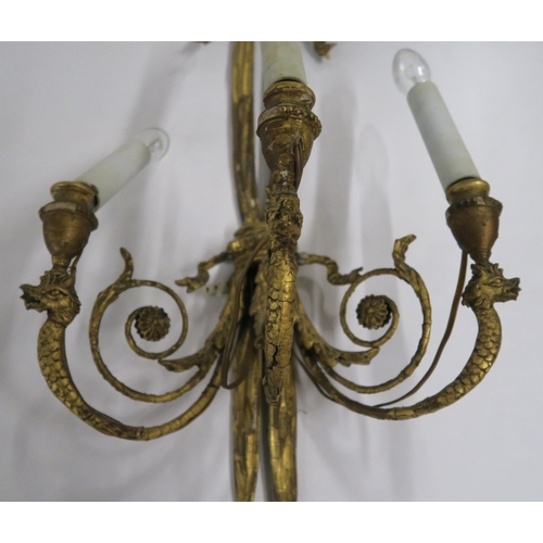 19 - A PAIR OF GILTWOOD AND GESSO WALL SCONCES with ribbon tied tasseled frames, joined by three foliate ... 