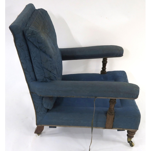 25 - A VICTORIAN HOWARD & SONS LTD OAK FRAMED UPHOLSTERED ARMCHAIR on turned front supports, stamped ... 