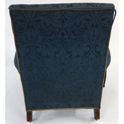 25 - A VICTORIAN HOWARD & SONS LTD OAK FRAMED UPHOLSTERED ARMCHAIR on turned front supports, stamped ... 
