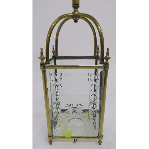 3 - AN EDWARDIAN BRASS AND CUT GLASS HALL LANTERN set with four foliate cut panels and base, 90cm high, ... 