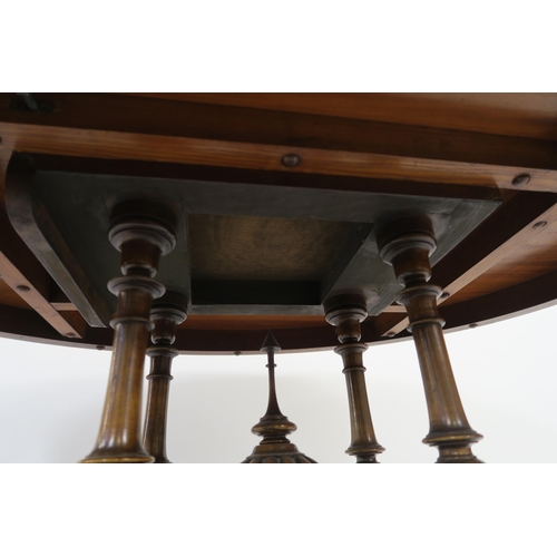 32 - A VICTORIAN WALNUT OVAL TILT TOP BREAKFAST TABLE on turned columns above carved quadripartite base 7... 
