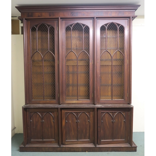 46 - A VICTORIAN MAHOGANY GOTHIC REVIVAL BOOKCASE,with three pierced grill doors above three stylized cab... 