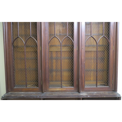 46 - A VICTORIAN MAHOGANY GOTHIC REVIVAL BOOKCASE,with three pierced grill doors above three stylized cab... 