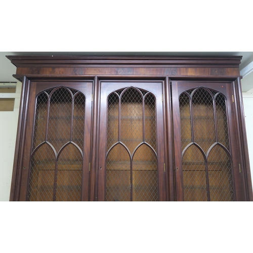 48 - A VICTORIAN MAHOGANY GOTHIC REVIVAL BOOKCASE,with three pierced grill doors above three stylized cab... 