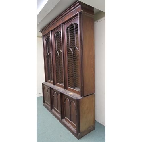 48 - A VICTORIAN MAHOGANY GOTHIC REVIVAL BOOKCASE,with three pierced grill doors above three stylized cab... 