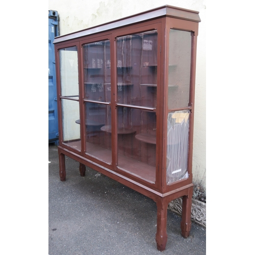 55 - AN EARLY 20TH CENTURY PAINTED PINE GLAZED DISPLAY CABINET,with glazed central sliding door flanked b... 