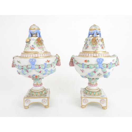 354 - A PAIR OF 19TH CENTURY MEISSEN URNS AND COVERS the finials modelled as globes of the world surrounde... 