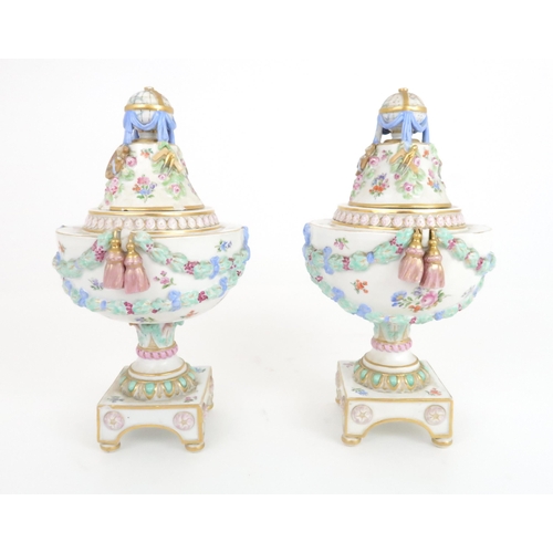 354 - A PAIR OF 19TH CENTURY MEISSEN URNS AND COVERS the finials modelled as globes of the world surrounde... 