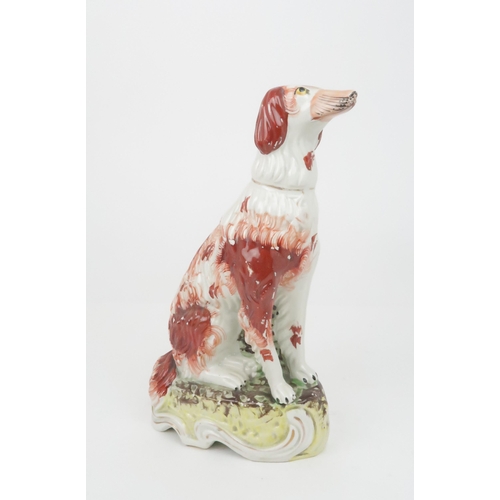 358 - A 19TH CENTURY STAFFORDSHIRE POTTERY DOG possibly an Irish Setter, modelled seated with red decorati... 