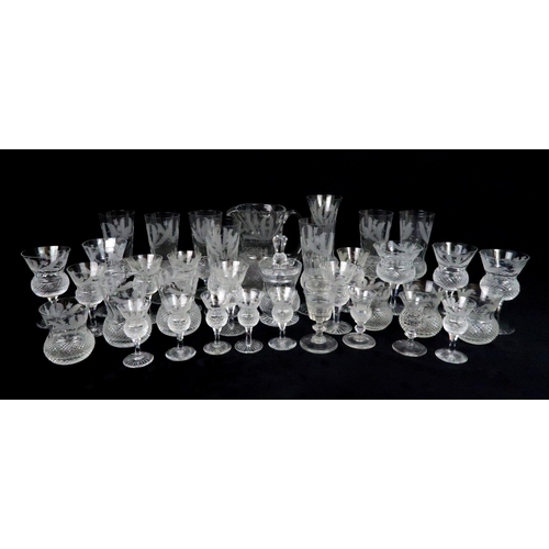 369 - A SUITE OF EDINBURGH THISTLE SHAPED GLASSWARE including seven flute champagne glasses, 17cm high, si... 