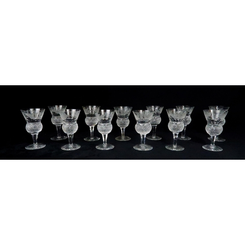 369 - A SUITE OF EDINBURGH THISTLE SHAPED GLASSWARE including seven flute champagne glasses, 17cm high, si... 