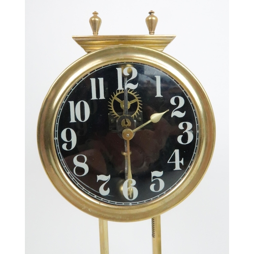 379 - A NEAR PAIR OF BRASS KEY LESS GRAVITY CLOCKSthe glass dial with white painted arabic numerals, both ... 